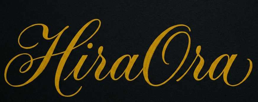 HiraOra logo in elegant gold calligraphy on a black background.